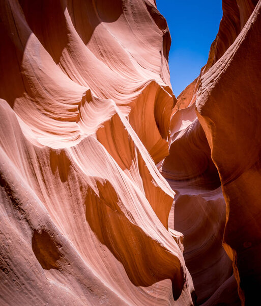 Erosion of sandstone rocks in and the blue sky of the lower Antelope Canyon. Arizona, United States