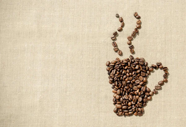 Descanso. Granos de café en el fondo de tela de lino — Foto de Stock