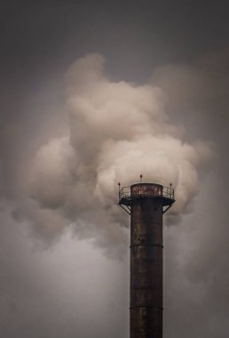 Çevre imha. Atmosfere zehirli gaz emisyonları. Fabrika İçilmeyen kasvetli bir gri gökyüzü arka planda boru. Atmosfere zararlı kimyasal emisyonları. Çevre kirliliği ve küresel ısınma
