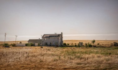 Lodi, California / USA - June 15 2017: old wooden house and farm buildings on a ranch in Ladai, California, USA. Arid California climate and dried grass on pastures. Summer trip to southwest USA