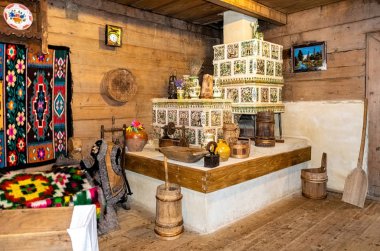 Bukovel, Ivano-Frankivsk region, Ukraine - Fabruary 23, 2020: Ancient interior of a rural house in an ethnographic park in the ski resort of Bukovel in the Carpathian mountains in Ukraine. Old wood stove and national-style living room decor