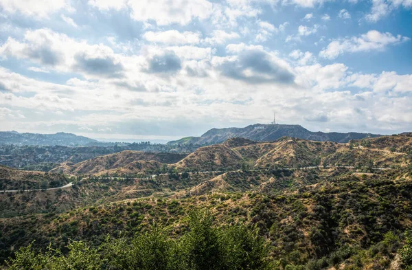 Los Angeles, California, USA - June 15, 2017: Famous Hollywood inscription in Griffith Hills Park in Los Angeles, California. Los Angeles famous tourist attraction and brand name, symbol of the US film industry.California arid summer landscape