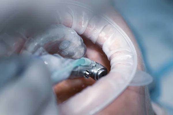 Dentist using dental drill. Close up dental drill on a light blurred background