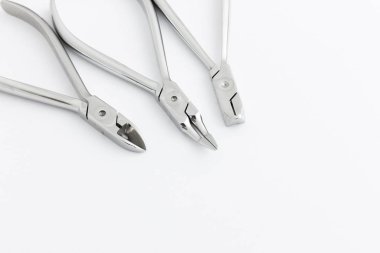 Beyaz arka planda diş bakımı için aletleri olan dişçi ofisi. Kıskaç azı dişi