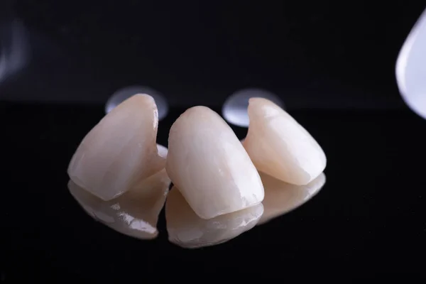 Dental Ceramic Crowns on black with mirror — Stok Foto