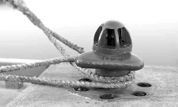 Black and white ship moor on Norway pier background