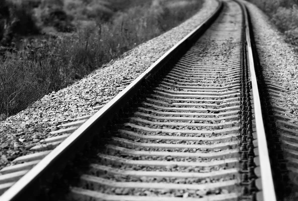 Diagonal black and white railroad track bokeh background — Stock Photo, Image