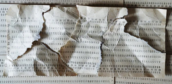 Horizontal crumpled punched card composition — Stock Photo, Image