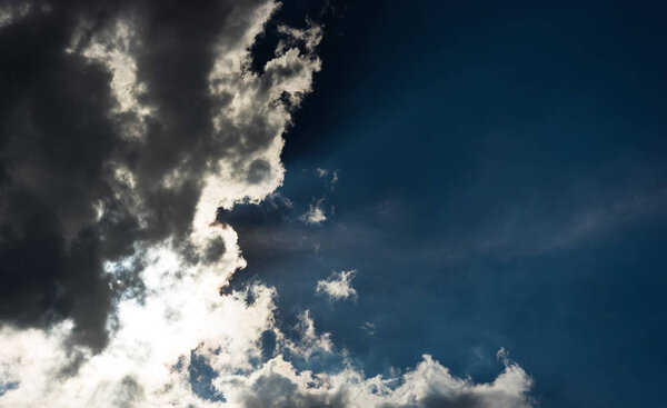 Sun glowing through the clouds background