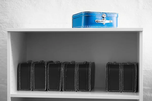 Caja de juguete azul con estuches en blanco y negro en el fondo del estante — Foto de Stock