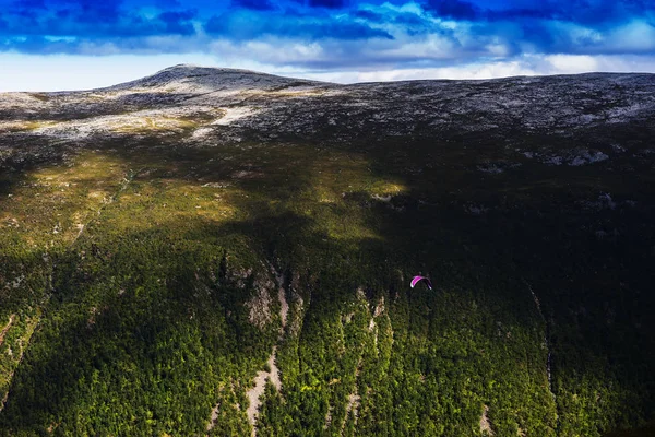 Norway daylight mountain with kite flyer landscape background