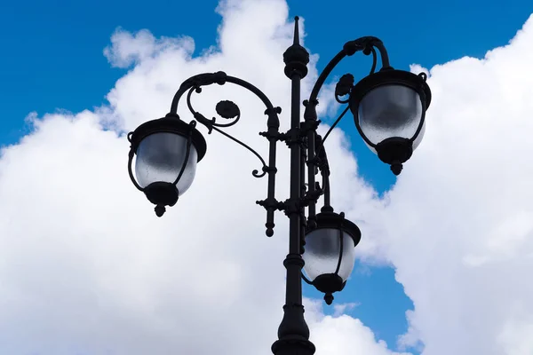 Vintage lamp on blue sky with clouds background Stock Photo