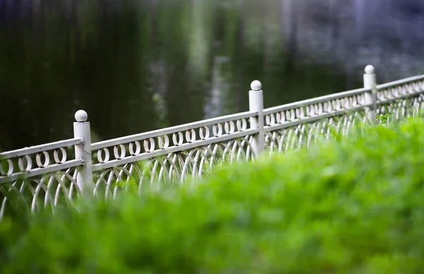 Horizontal diagonal fence in park bokeh background backdrop — Stock Photo, Image