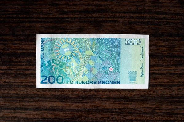 200 Norwegian krones back on wood desk background