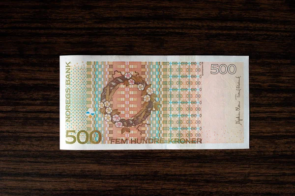 500 Norwegian krones back on wood desk background