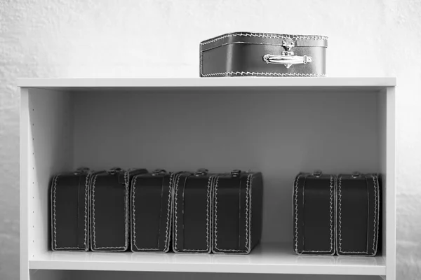 Black and white toy cases on the shelf background — Stock Photo, Image
