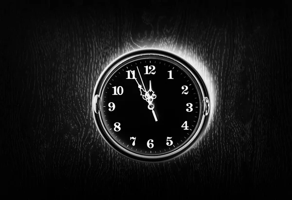 Dark vintage clock on the wall texture background