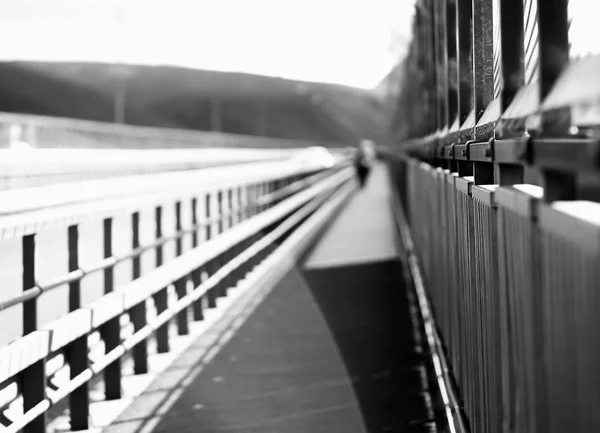 Black and white walking man on Norway bridge background — Stock Photo, Image