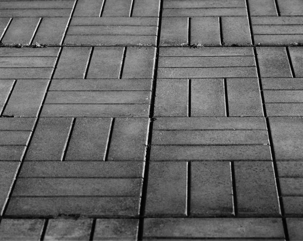 Black and white street tiles in perspective texture background — ストック写真