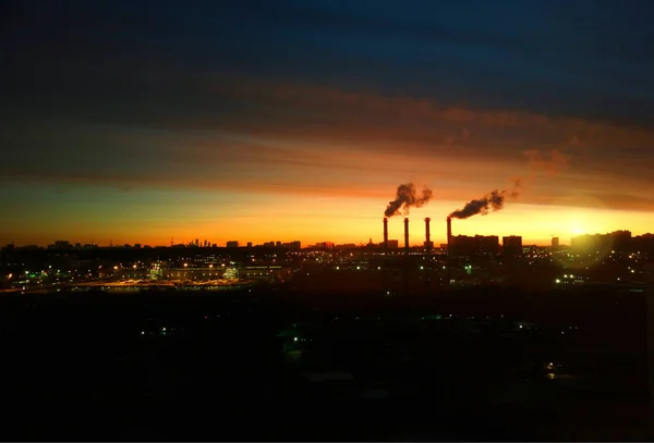 Dramatic industrial chimneys during sunset background — Stock Photo, Image