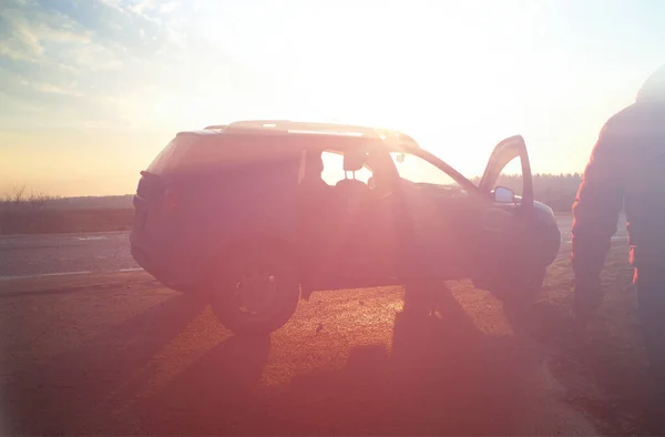 Shined car on sunset road travel background