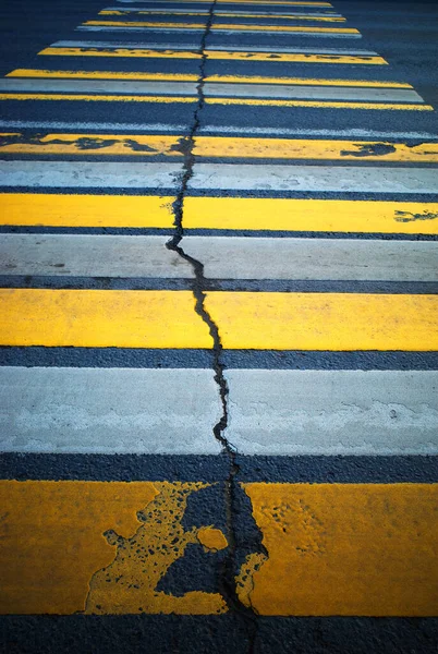 Old pedestrian crossing with cracked road background