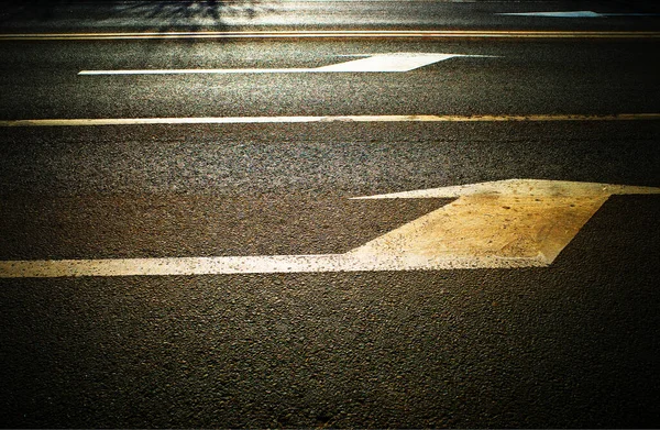 Transportation arrows on street road background