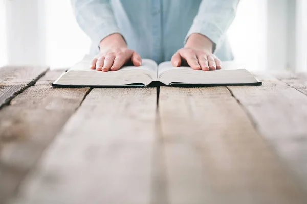 Mujer leyendo y rezando sobre la Biblia — Foto de Stock