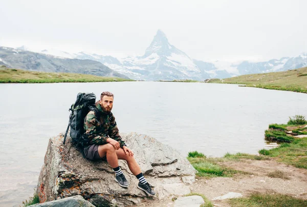 Jovem caminhante está descansando ao lado de um lago na Suíça Alpes. Próximo — Fotografia de Stock