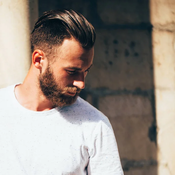 Rahat kentsel tarzı logo veya tasarım alanı olan beyaz boş t-shirt giyen sakallı hippi yakışıklı erkek modeli