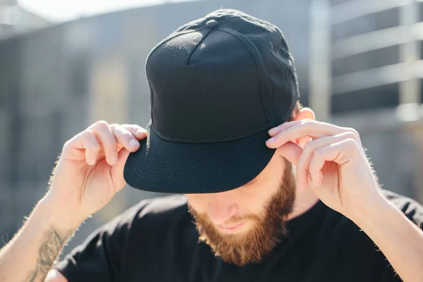 Hipster handsome male model with beard  wearing black blank  bas — Stock Photo, Image