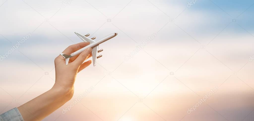 Woman holding airplane in hands