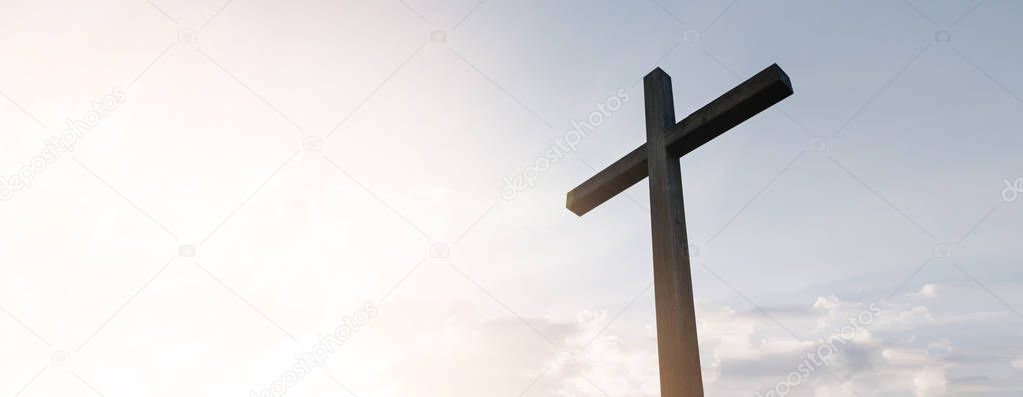 Wooden cross over sunrise background