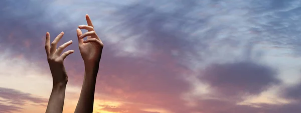 Hand reaching for the sky or for God with dark stormy clouds — Stock Photo, Image