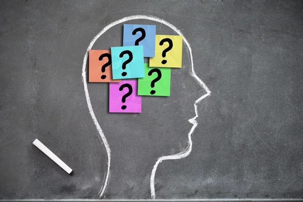 Chalk drawn head with question stickers — Stock Photo, Image