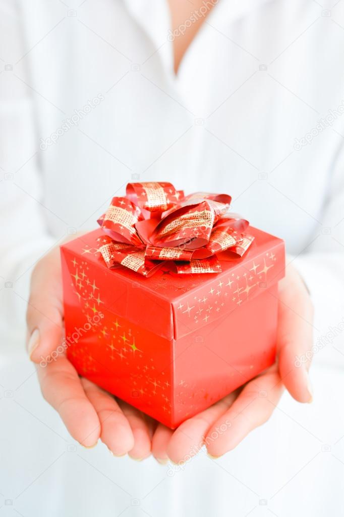 hands holding red gift box