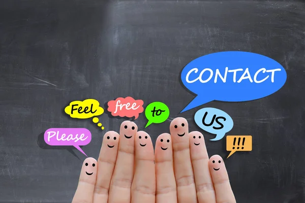 Contact us concept with happy fingers on blackboard background — Stock Photo, Image