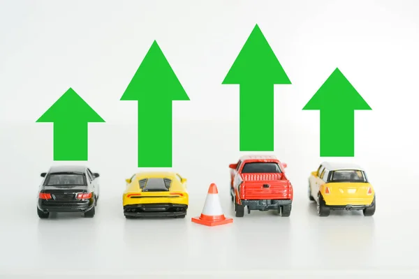 Toy cars models with green arrows suggesting automotive industry growth — Stock Photo, Image