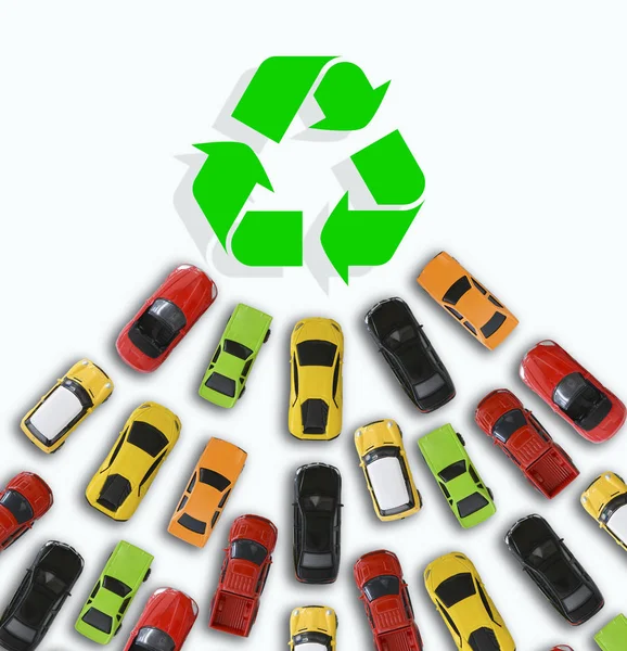 Car toys heading towards a green energy symbol or sign suggesting sales growth of electric vehicles — Stock Photo, Image