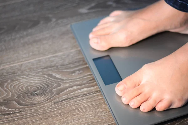 Diet concept with woman on weight scale — Stock Photo, Image