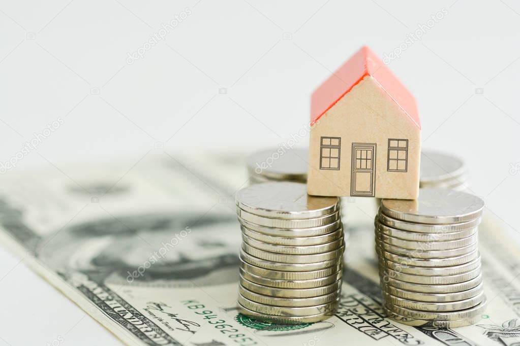 House property prices concept with money pillars from coins