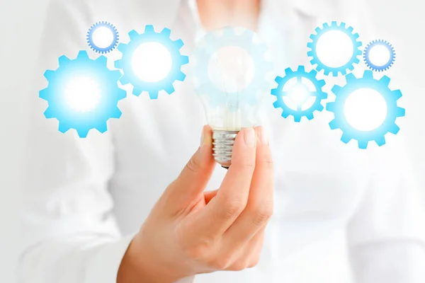 Business innovation concept with light bulbs and spinning gears — Stock Photo, Image