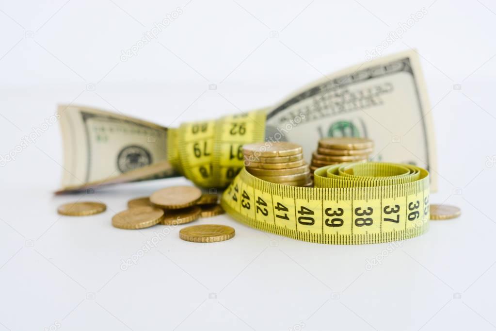 Dollar bills tied up with measuring tape suggesting measurement of financial success