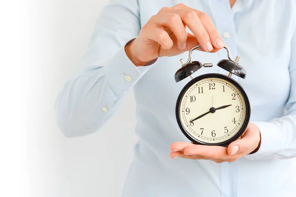 Businesswoman holding an old clock in hands suggesting deadline concept — Stock Photo, Image