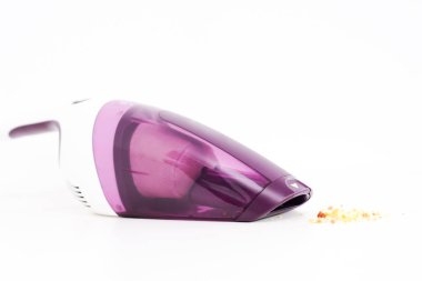 Purple hand held vacuum cleaner isolated on white background clipart