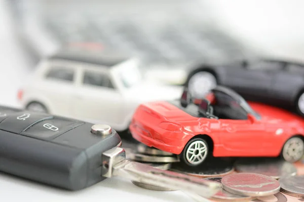 Car insurance concept with colorful toy cars, car key, coins and bills — Stock Photo, Image