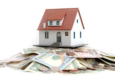 Model house on top of money pile suggesting savings for a house clipart