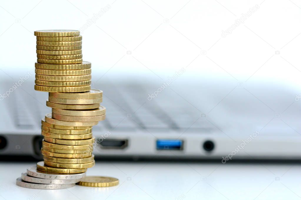 Growth of the revenues from online activities with stack of coins and notebook