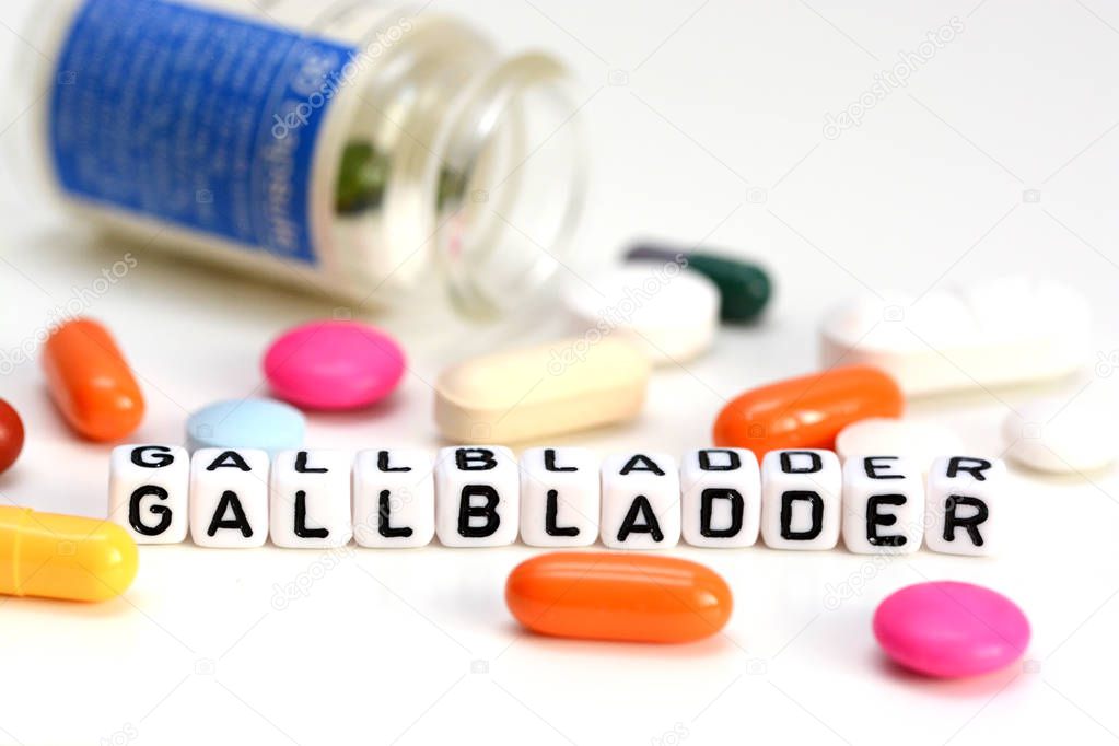 Gallbladder problems concept with colorful drugs out of container and gallbladder word from white cubes