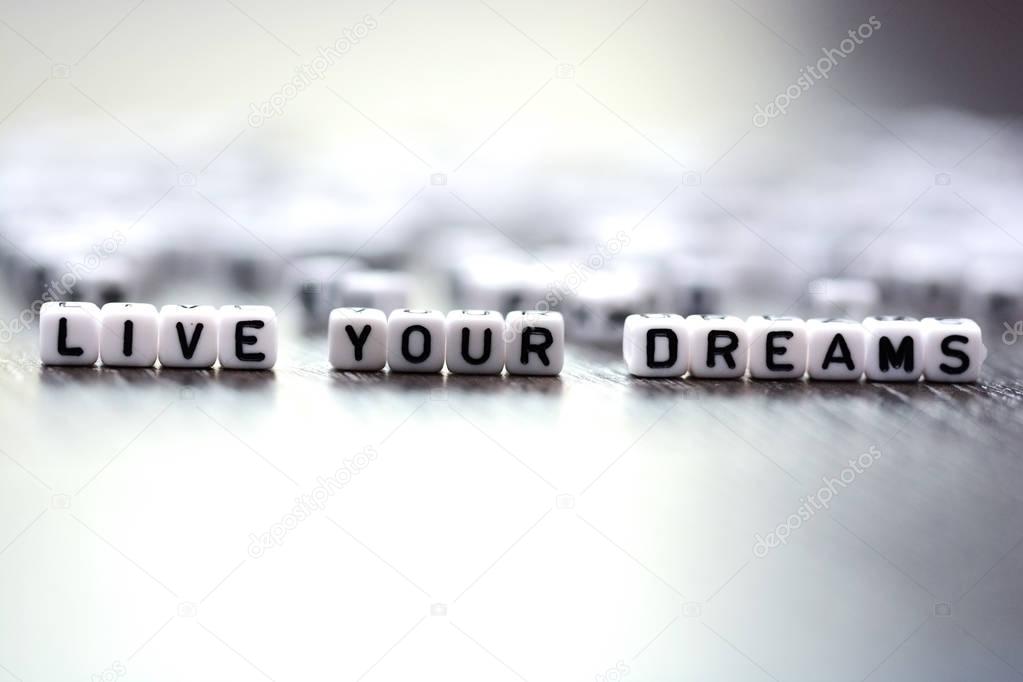 Live your dreams advice spelled by plastic letter beads